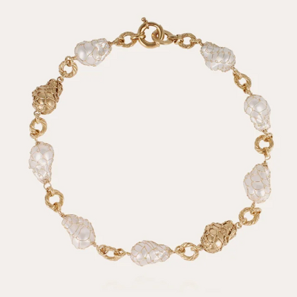 Collar bañado en oro , compuesto por finos anillos ensamblados con delicadas cuentas de resina perlada ligeras, montadas sobre un engarce.