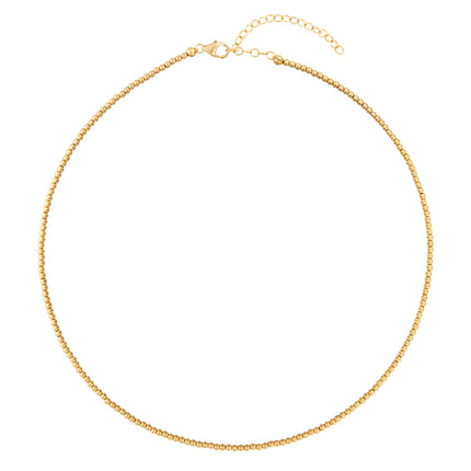 Este collar de bolitas de 2 mm en oro laminado 14K aporta luz con naturalidad, creando una base limpia que eleva cualquier combinación. Un brillo sutil que acompaña sin imponerse.